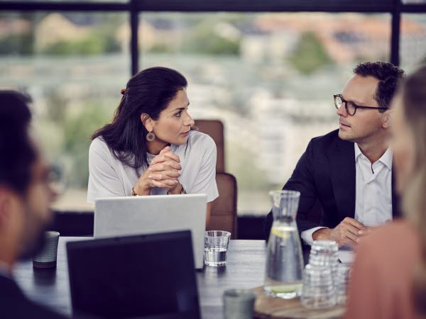 Woman and man talking with each other during a meeting