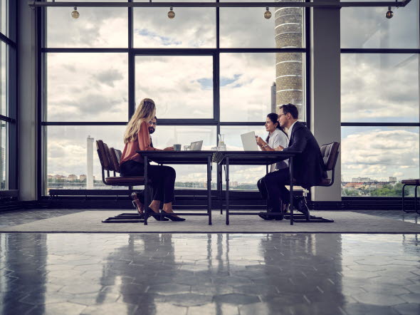 A group of people sitting around a large table