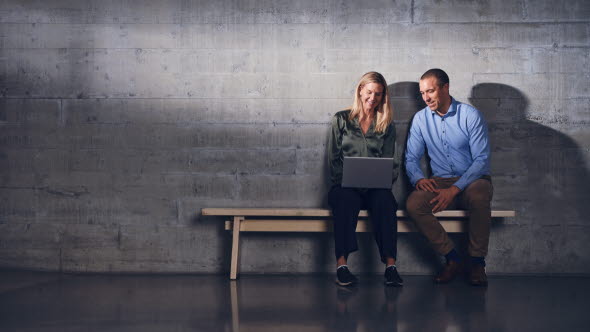 Woman and man sitting together looking at a computer